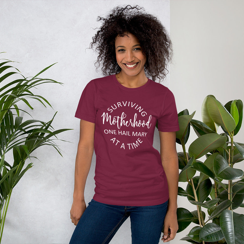 Surviving Motherhood One Hail Mary at a time t-shirt in maroon